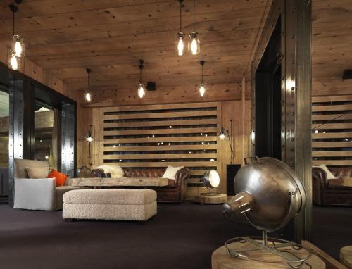 a living room with a couch and a table at M de Megève in Megève