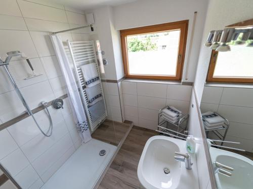 a bathroom with a sink and a shower and a toilet at Ferienhof Biegger in Tettnang
