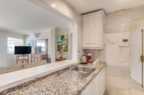 a kitchen with a sink and a counter top at Deluxe Apartment with Jacuzzi in Marbella