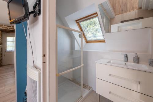 a tiny house with a sink and a mirror at Gîtes Ker Mané in Erdeven
