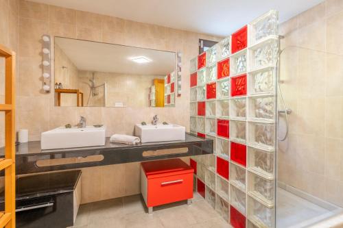 a bathroom with two sinks and a mirror at Villa Sant Vicente in Cala de Sant Vicenc