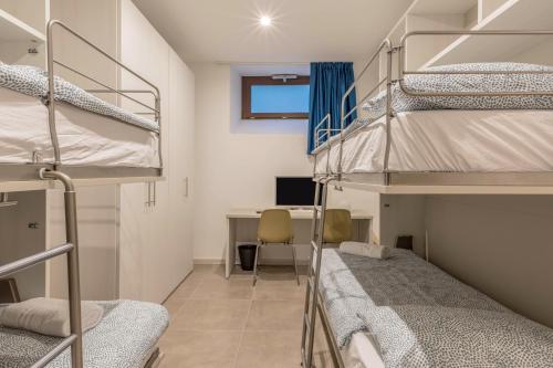 a dorm room with bunk beds and a desk at Casa Balansina Lake View in Brenzone sul Garda