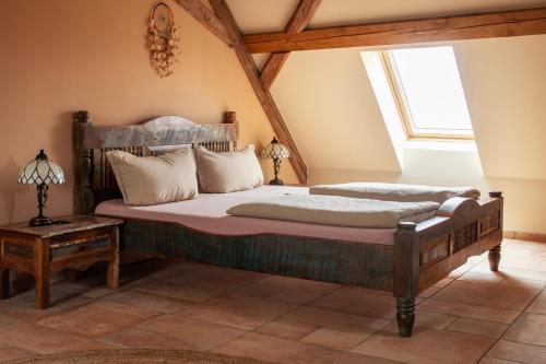 a bedroom with a bed and a window at Fewo Hohe Liebe in Rathmannsdorf