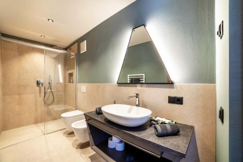 a bathroom with a sink and a shower at Aktiv Lodge Meran - Terrace Large in San Martino