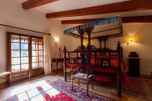 a bedroom with a canopy bed and a rug at Plana Morro in Pollença