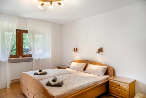 a bedroom with a bed with two hats on it at Auszeit Brunner in Bad Tölz