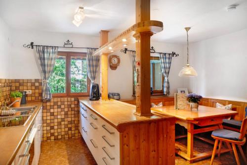 a kitchen with a wooden counter top and a table at Auszeit Brunner in Bad Tölz