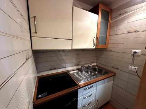 a small kitchen with a sink and a stove at Appartamento Bardonecchia in Bardonecchia