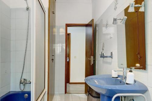 a bathroom with a blue sink and a shower at Vermarl - Viana do Castelo in Linhares de Cima