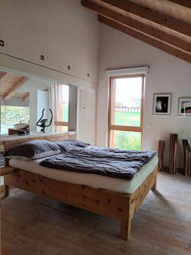 a bedroom with a wooden bed in a room at Haus am Teich mit privater Sauna in Sankt Leonhard bei Freistadt