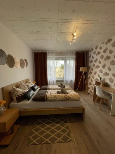 a bedroom with a large bed and a window at Ruhige Ferienwohnung Zeithain in Zeithain