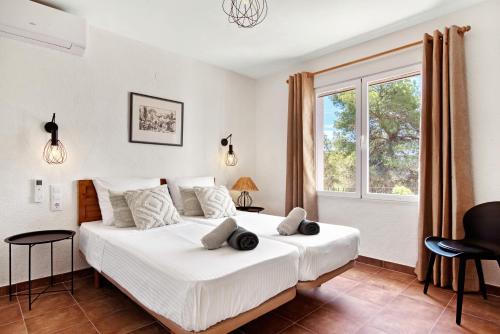 a bedroom with a large bed and a window at Casa Crystal in Jávea