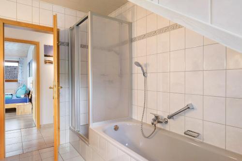 a bathroom with a shower and a bath tub at Ferienwohnung Sulzberg, 103qm in Alpirsbach