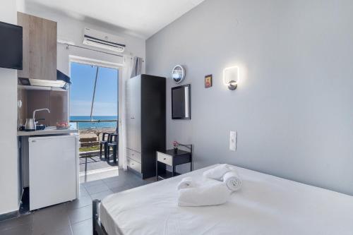 a bedroom with a bed and a view of the ocean at Iguana studio 13 in Preveza
