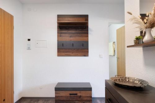 a living room with white walls and wood accents at Fewo Kessler Waldblick in Häusern