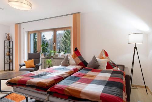 a bedroom with a large bed in a room at Fewo Kessler Waldblick in Häusern