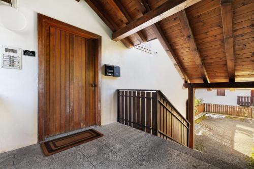 an entrance to a house with a wooden door at La finestra sui monti - Breguzzo in Breguzzo