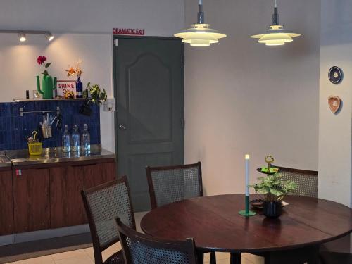 a dining room with a table with a candle on it at Dramatic Exit Bangkok - Cozy Loft House near Suvarnabhumi Airport in Bangkok