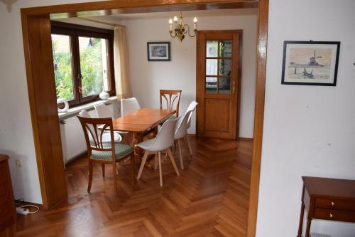a dining room with a wooden table and chairs at Landhaus Eva-maria in Elbingerode
