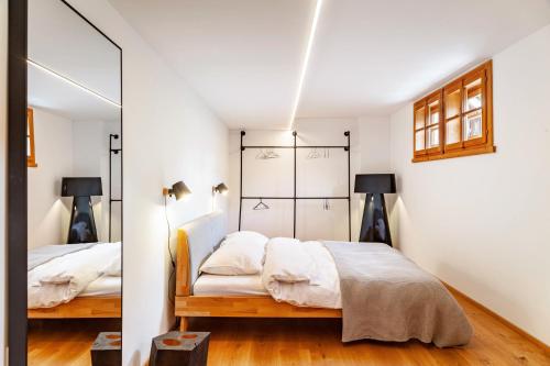 a bedroom with two beds and a mirror at Chalet Flocke Appart Schneehase in Sankt Anton am Arlberg