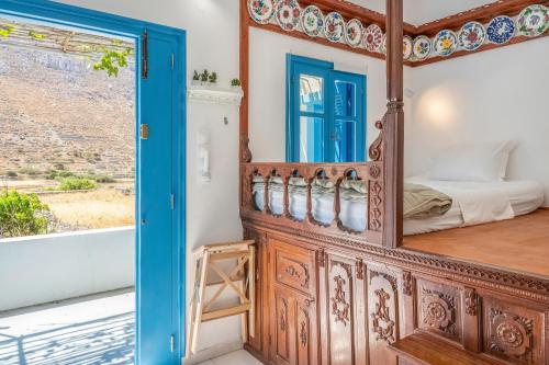 a room with a bed and a mirror at Avlona Blue in Diafani