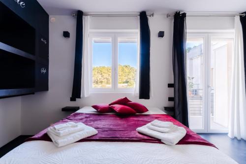 a bedroom with a large bed with red pillows at Suite Black and White in Otranto