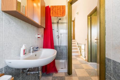a bathroom with a sink and a shower at Villetta Stella in Chia