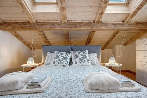 a bedroom with a blue bed with pillows at Wellness Lodge Chicca in Santa Giuliana