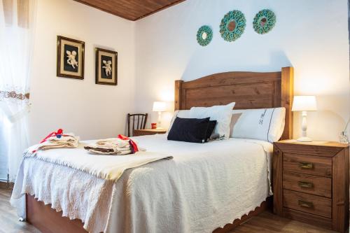 a bedroom with a large bed with a wooden headboard at La Plazuela I in Pereña