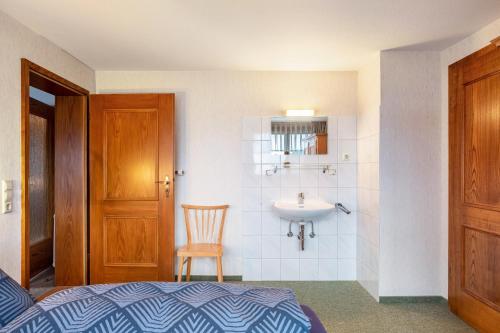 a bedroom with a sink and a bathroom with a bed at Haus Irmgard in Lenzkirch
