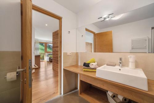 a bathroom with a white sink and a mirror at Ederhof in Schenna