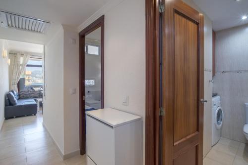 a bathroom with a washer and dryer in a room at Stunning Marina view apartment in Fuengirola