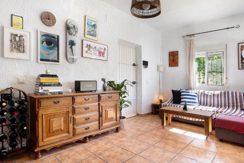 a living room with a couch and a wooden dresser at Casa Luna in Los Caños de Meca