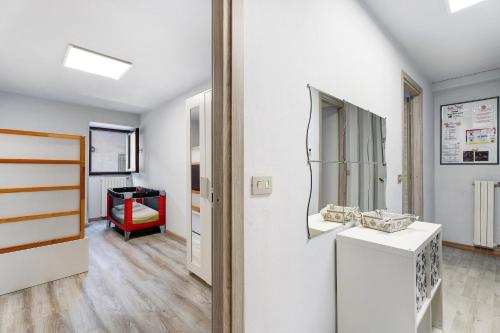 a room with white walls and a mirror at Casa Vacanza Malva in Baveno