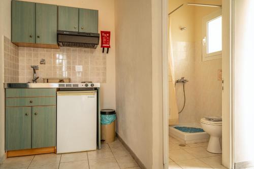 a small kitchen with a sink and a toilet at Anemona studio E in Kefallonia