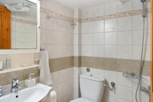 a bathroom with a toilet and a sink at Argyris comfy apartment in Kithnos