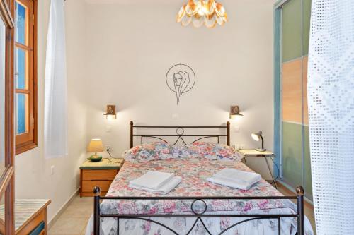 a bedroom with a bed with two towels on it at Argyris comfy apartment in Kithnos