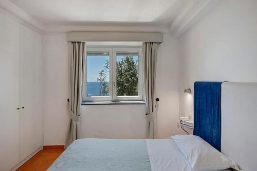 a bedroom with a bed and a window at Suite Aurora in dependance in Conca dei Marini