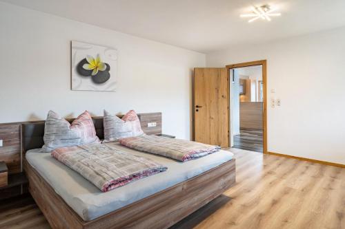 a bedroom with a large bed with a wooden headboard at Steinwender in Kaltenbach