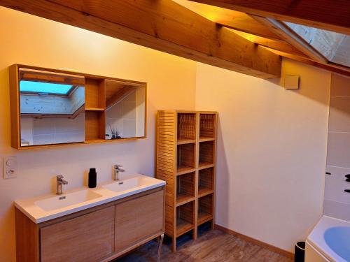 a bathroom with a sink and a mirror at Le Refuge - Faucigny in Faucigny
