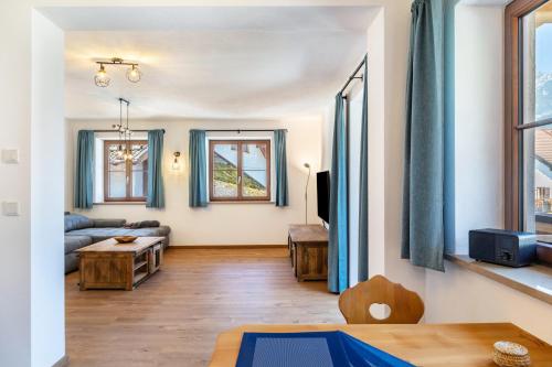 a living room with a couch and a table at Beim Schweizer in Garmisch-Partenkirchen