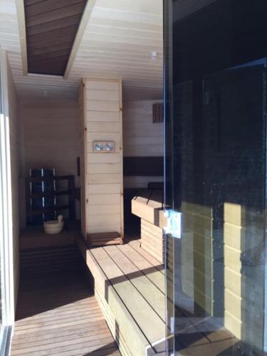 a sauna with wooden steps and a glass window at Italian Heaven in Perledo