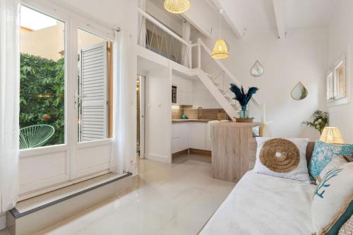 a living room with a couch and a large window at Appartement Pinède in Cap d'Agde