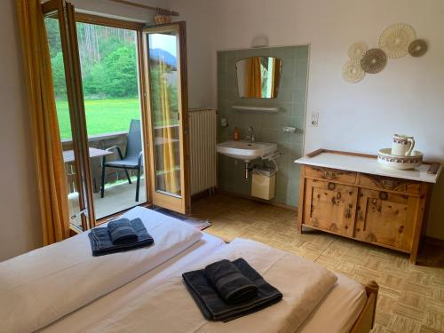 a bedroom with a bed with two towels on it at Ferienwohnung Durst 1 in Mayrhofen