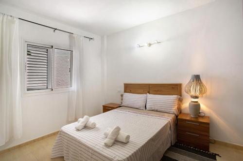 a bedroom with a bed with two towels on it at Rach Agaete in Agaete