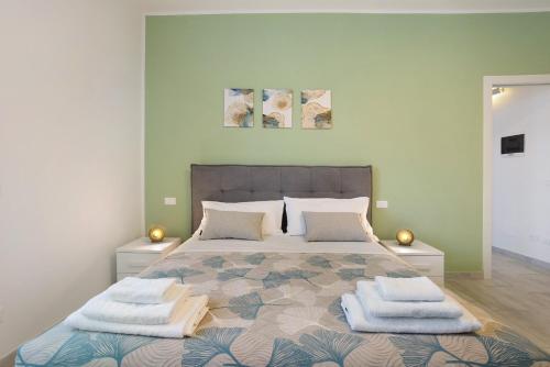 a bedroom with a large bed with towels on it at Suite Ponte Vecchio in Pavia
