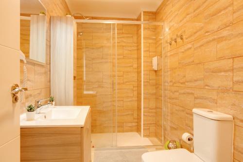 a bathroom with a shower and a toilet and a sink at 1a Van Halen in Vecindario