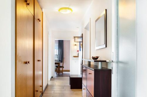 a hallway leading to a home with white walls and wood floors at Fewo Kleinert in Billingsbach