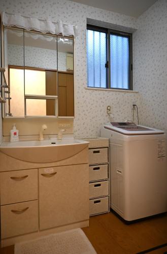 a bathroom with a sink and a mirror at 心宿 伏見稲荷 in Kyoto