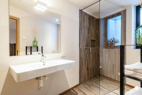 a bathroom with a sink and a shower at Aumia Apartment Opal in Völs am Schlern